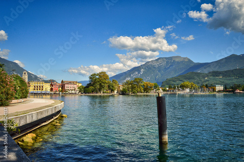 view to Riva del Garda, mountains, Monte Brione, lake, water, pier, promenade, pale, blue sky photo