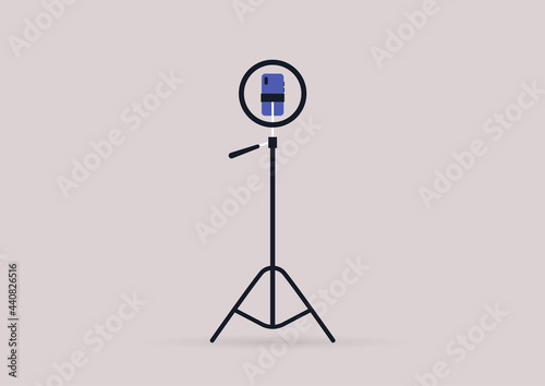 An isolated tripod with a ring light and a smartphone installed inside it