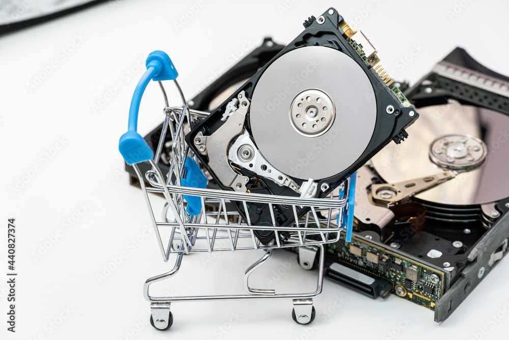 Open hard disk drives in shopping cart. Information, data storage infrastructure cost concept. Open hard disk drives in shopping cart. Information, data storage infrastructure cost concept.