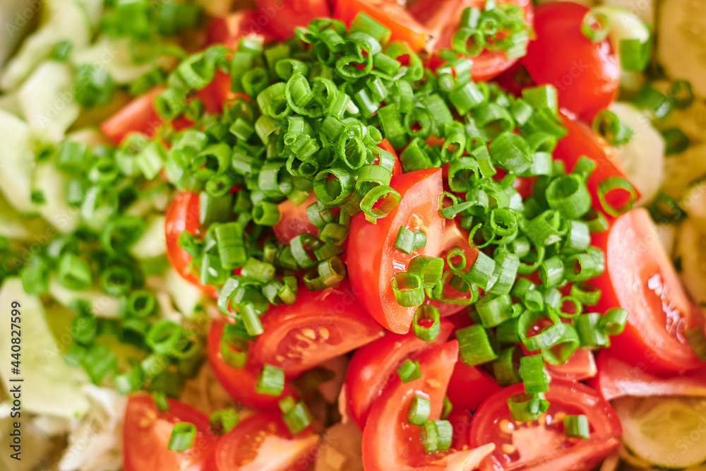 Macro photo of fresh red tomatoes and green onions salad. Food background Macro photo of fresh red tomatoes and green onions salad. Food background