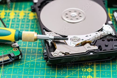 hard disk drive disassembling process with screwdriver in information recovery, repair HDD service