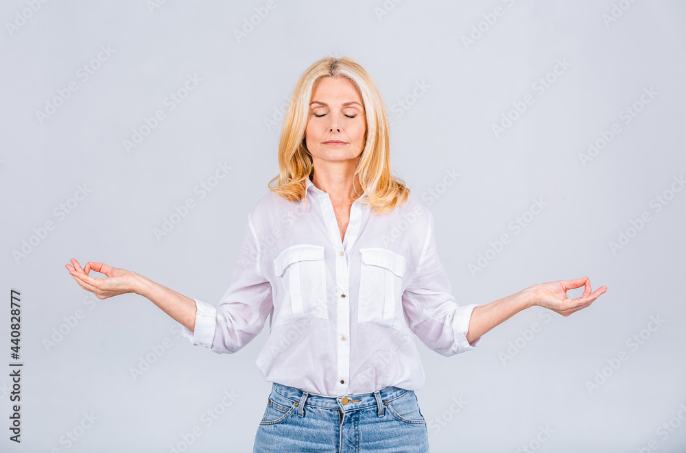 Just relax! Photo of happy positive good mood dreamy woman doing yoga meditating relaxing isolated on grey or white color background. Just relax! Photo of happy positive good mood dreamy woman doing yoga meditating relaxing isolated on grey or white color background.