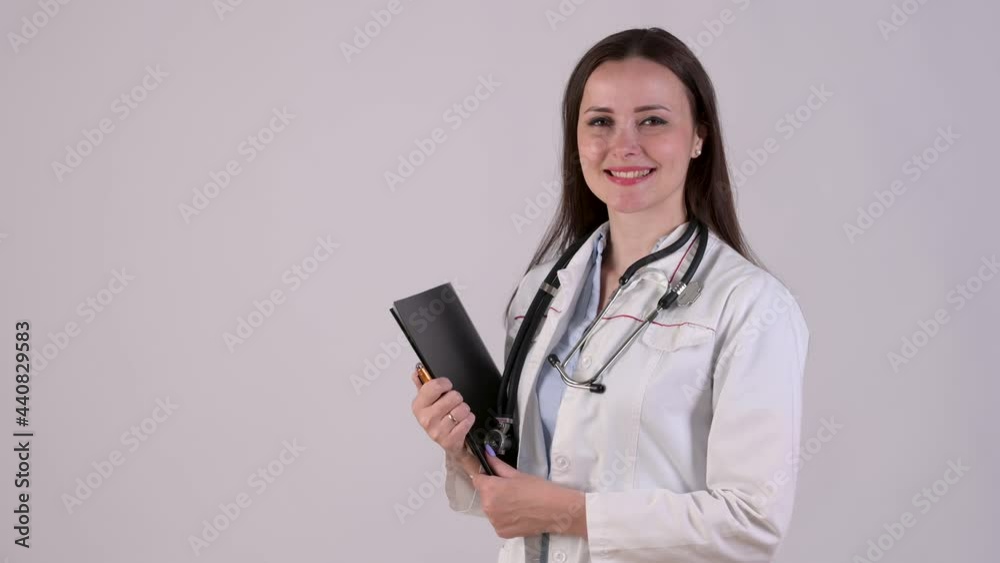 Portrait of smiling Female Doctor in medical Uniform holding clipboard isolated on white background. Medical workers. Portrait of smiling Female Doctor in medical Uniform holding clipboard isolated on white background. Medical workers.