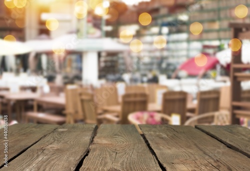 Empty wood table top and blurred restaurant interior background.
