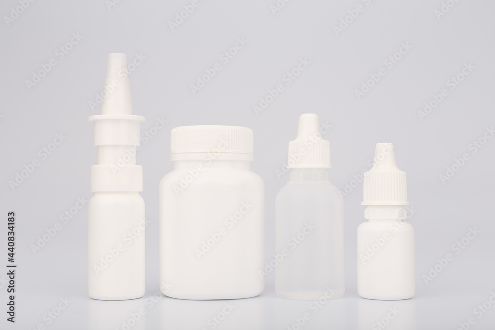 Nose spray, medication bottle with pills, eye drops and ear drops isolated on white background. Concept of medical treatment of cold and flu Nose spray, medication bottle with pills, eye drops and ear drops isolated on white background. Concept of medical treatment of cold and flu