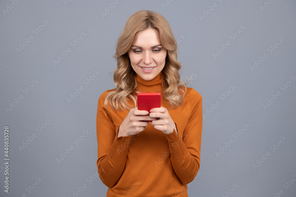 Pretty woman text short message on mobile phone device grey background, sms