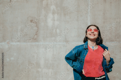 Cheerful woman wearing pink sunglasses posing with closed eyes © Yakobchuk Olena