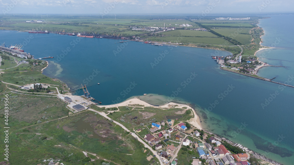 Aerial view of the sea bay. Blue water and boat trail.
