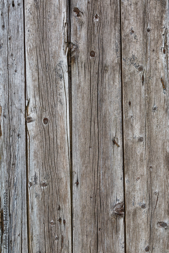 Fototapeta premium Old wooden fence gray-brown boards with cracked. Beautiful textured background for design.Old Vintage Rough Wood Bars Fence Texture Background.