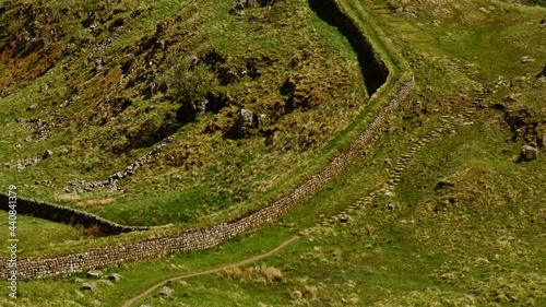Cinematic view of Hadrian's Wall, ordered by the namesake Roman emperor in AD 122 in today's Northumberland region, North East England, UK. Hadrian's Wall is a UNESCO World Heritage Site photo