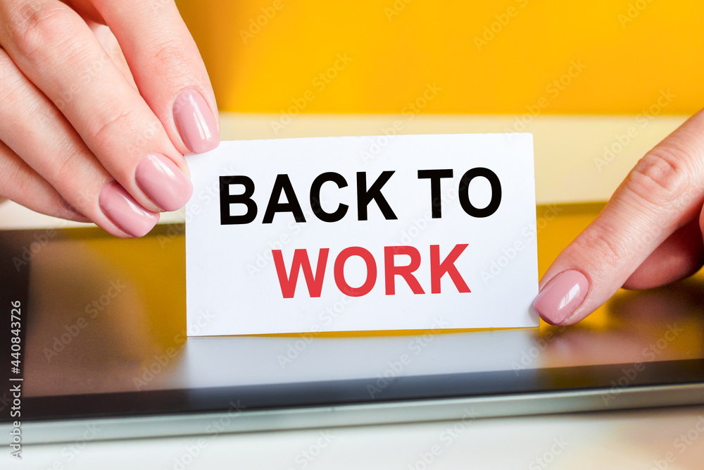 woman holds a piece of paper with the text back to work, concept woman holds a piece of paper with the text back to work, concept