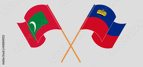 Crossed and waving flags of Maldives and Liechtenstein