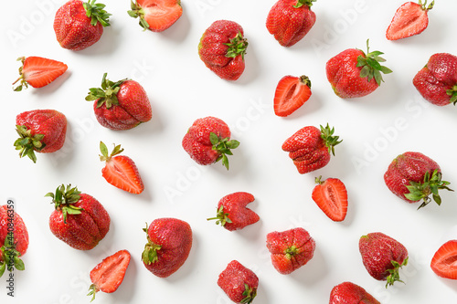 Pattern of ugly organic strawberry on white background. View from above. Concept organic products.