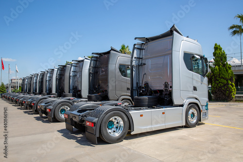 New heavy trucks in truck store, trucks lined up  photo