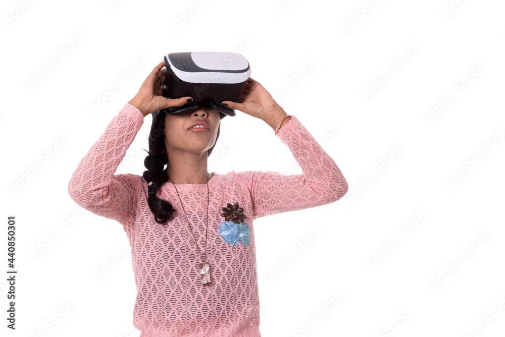 Beautiful girl looking though VR device. Young girl wearing virtual reality goggles headset. Beautiful girl looking though VR device. Young girl wearing virtual reality goggles headset.