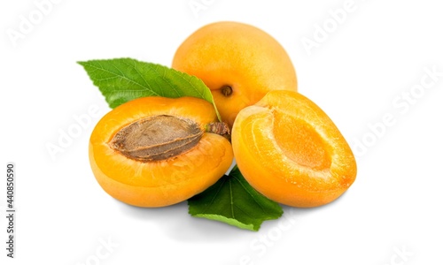 Ripe apricots with leaves isolated on white background