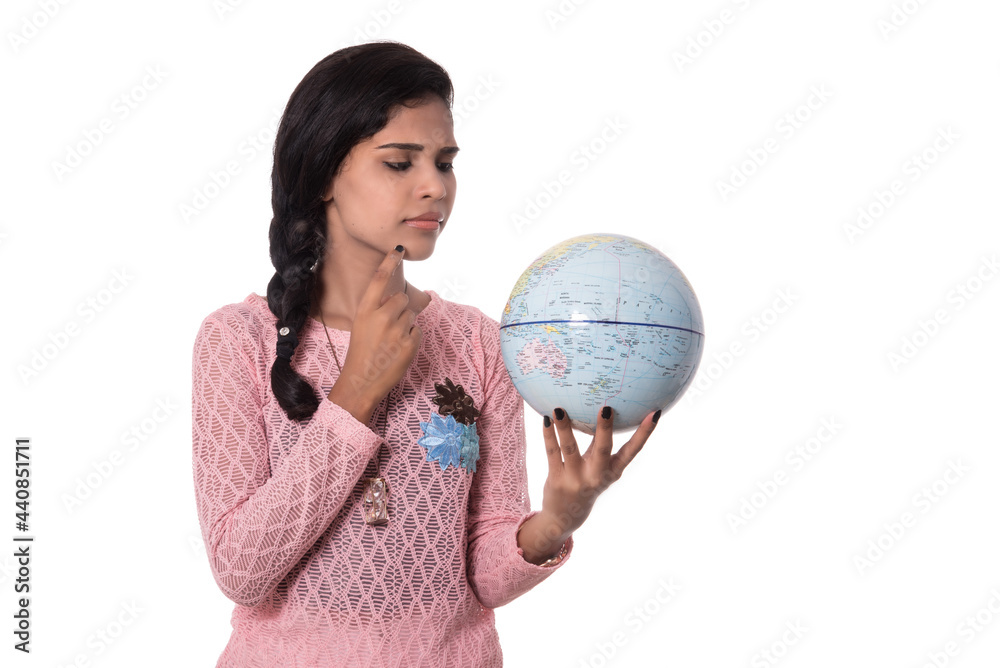Beautiful Girl holding a world globe isolated on a white background Beautiful Girl holding a world globe isolated on a white background
