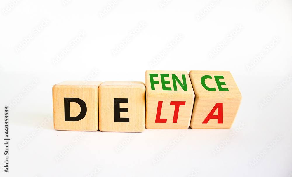 Covid-19 delta variant strain defence symbol. Turned the wooden cube and changed the word delta to defence. Beautiful white background. Covid-19 delta variant strain defence concept. Copy space. Covid-19 delta variant strain defence symbol. Turned the wooden cube and changed the word delta to defence. Beautiful white background. Covid-19 delta variant strain defence concept. Copy space.