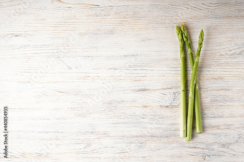Fresh asparagus on wooden background  space for text. Flat lay.