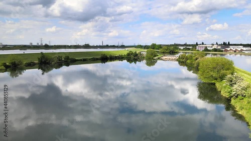 Sunny windless day at Walthamstow Reservoirs. Drone flying above water surface mirroring sky photo