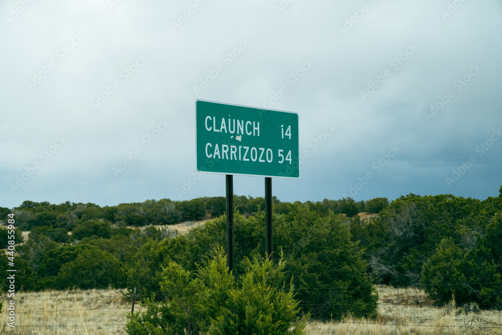 Directional mileage road sign in New Mexico for two small towns - Claunch and Carrizozo