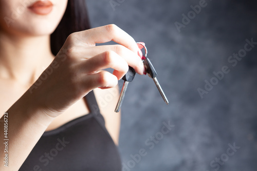 young woman holding keys in her hands