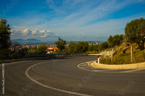 VLORA, ALBANIA: Paved road goes serpentine, view of the city of Vlora and Sazani Island. photo