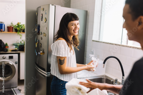 Obraz na plátně Woman doing the dishes with her boyfriend