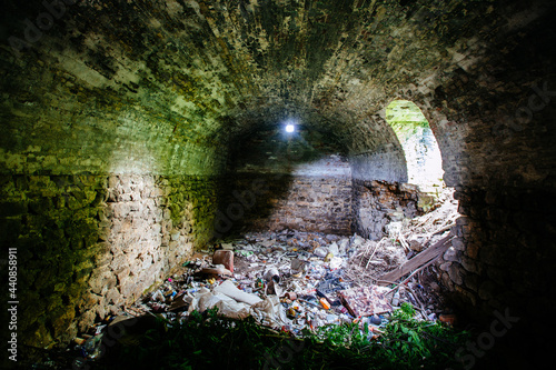 Fototapeta Naklejka Na Ścianę i Meble -  Abandoned empty old dark underground vaulted cellar