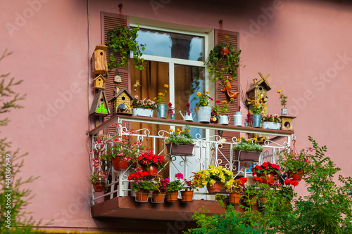 A picturesque balcony of the house  decorated with flowers and various objects