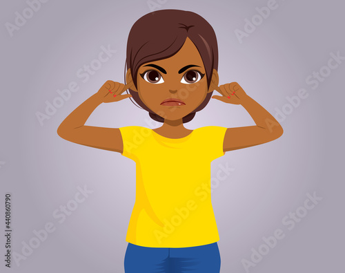 Black girl looking upset gesturing with fingers on ears dont want to hear concept