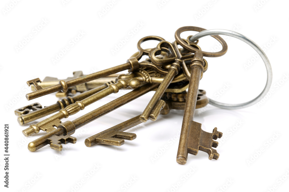 old brass key against a white background old brass key against a white background