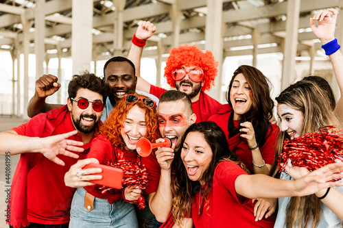 Photography Group of multiracial supporter sport fans taking selfie with mobile phone while