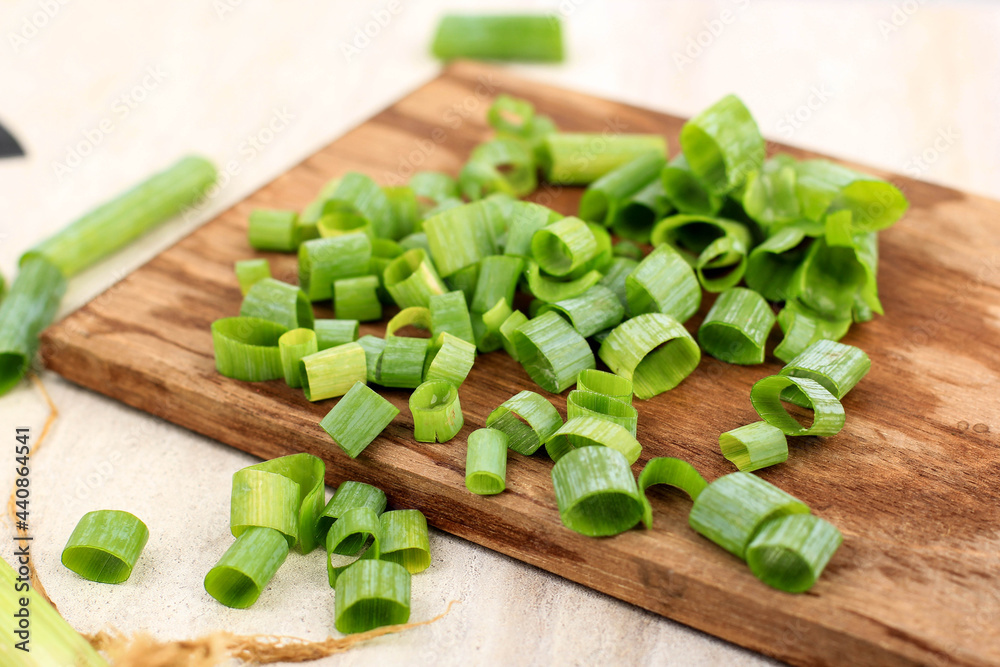 Sliced, chopped spring onions, salad onions, green onions or scallions on Wooden Chopping Board, Cooking Step by Step Sliced, chopped spring onions, salad onions, green onions or scallions on Wooden Chopping Board, Cooking Step by Step