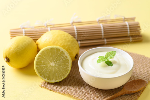 Fresh lemon and yogurt in a bowl with mint leaf, Healthy eating and beauty skincare