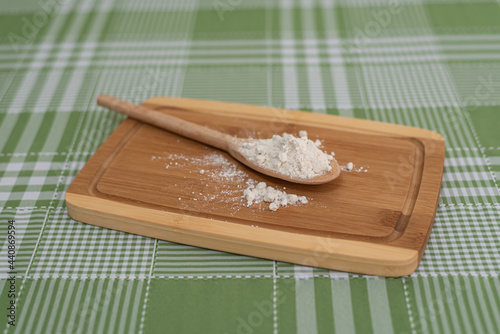 Table with wooden spoon with flour