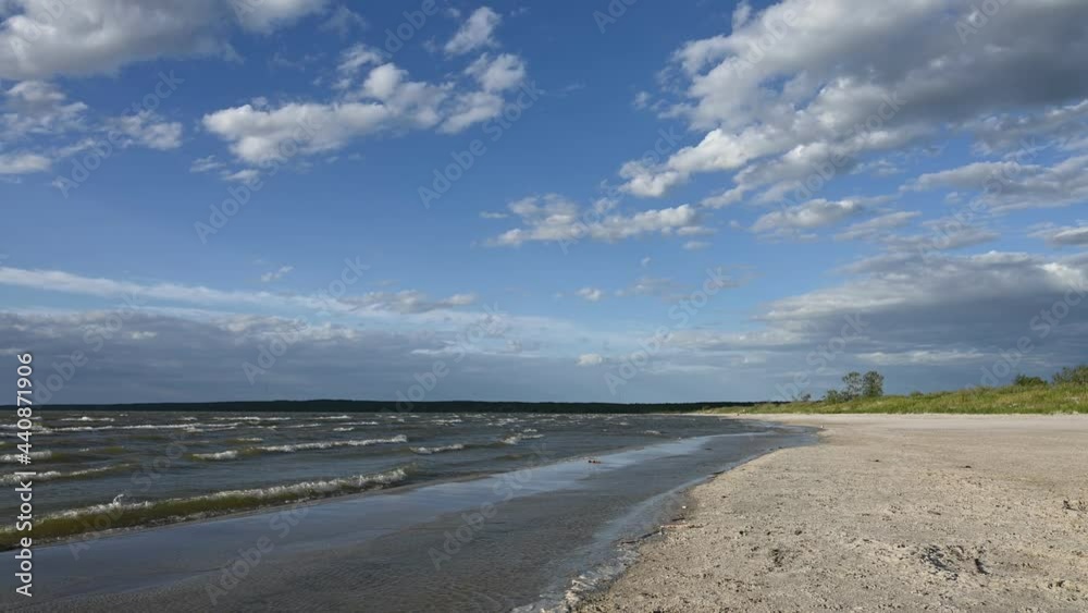 Waves breaking on a sandy beach under a blue sky with white clouds. Filmed at 60fps.
Waves breaking on a sandy beach under a blue sky with white clouds. Filmed at 60fps.