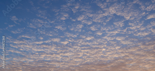 Cirrus cloudscape on blue sky. The evening sunset. Majestic Clouds.