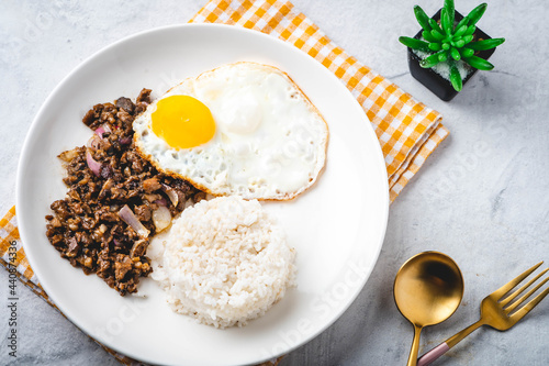 SisigSilog- is a typical Filipino Breakfast meal, consisting usually of sisig (a dish made from parts of a pig's face and belly, and chicken liver) , fried egg and fried rice