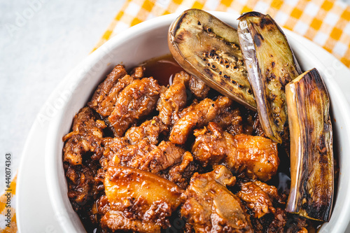 Pork Binagoongan -is a type of pork stew wherein pork slices (usually the belly part), are sautéed in onion, garlic, and tomato, and then cooked with shrimp paste garnished with fried eggplant. photo