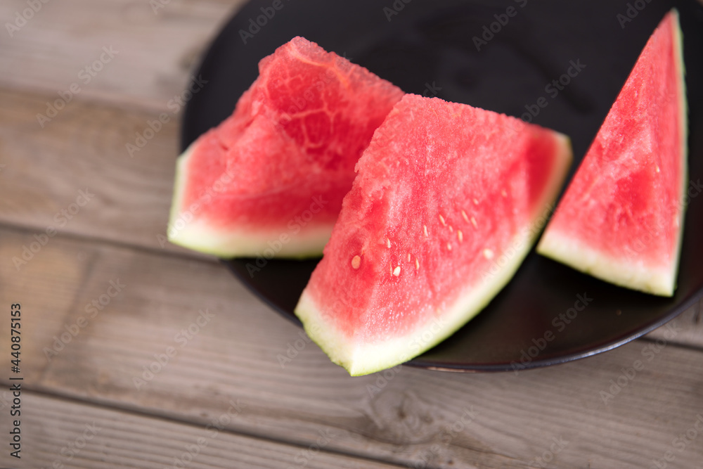 A few pieces of red stuffed watermelon on a plate A few pieces of red stuffed watermelon on a plate