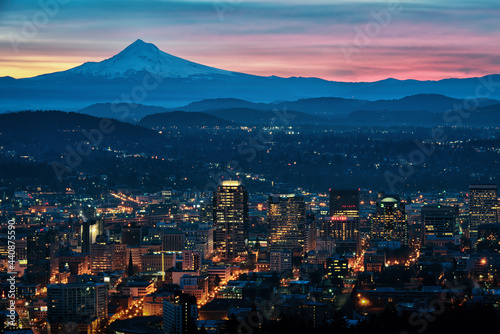 A colorful cityscape sunrise with Mt Hood and the city lights of Portland, Oregon