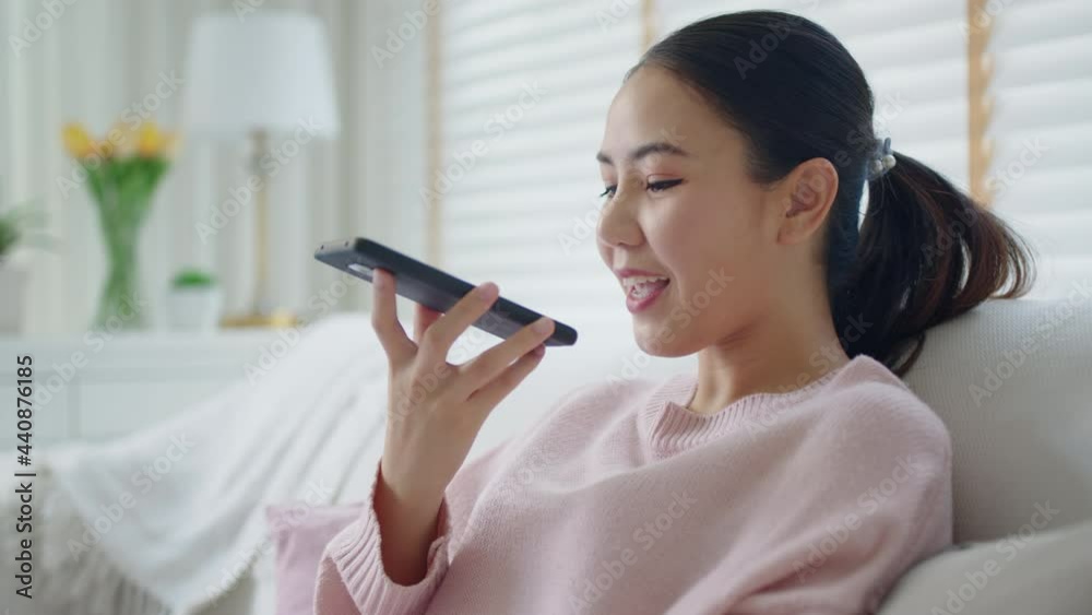 Asia young people teen happy girl sit relax call use smart phone talk chat send text to 5G wifi mic VoIP deep tech ai bot app at home sofa couch. Enjoy vocal order to help chatbot iot on social media. Asia young people teen happy girl sit relax call use smart phone talk chat send text to 5G wifi mic VoIP deep tech ai bot app at home sofa couch. Enjoy vocal order to help chatbot iot on social media.
