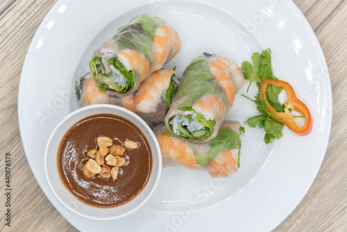 Overhead view of hearty plate of shrimp spring rolls loaded and sliced for a complete appetizer