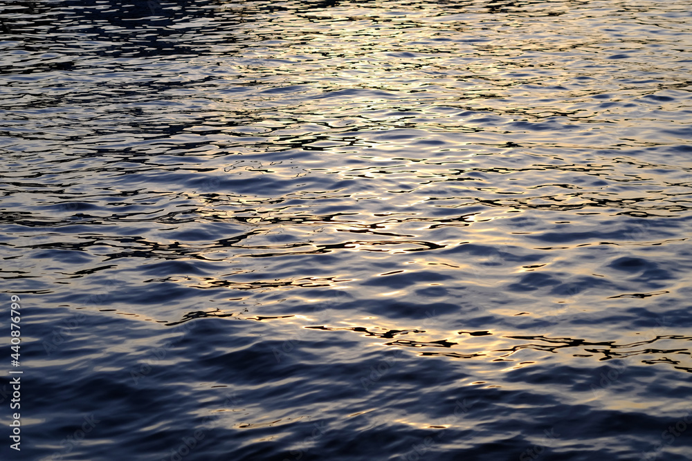 blue water wave with reflection of sunlight at sunset blue water wave with reflection of sunlight at sunset