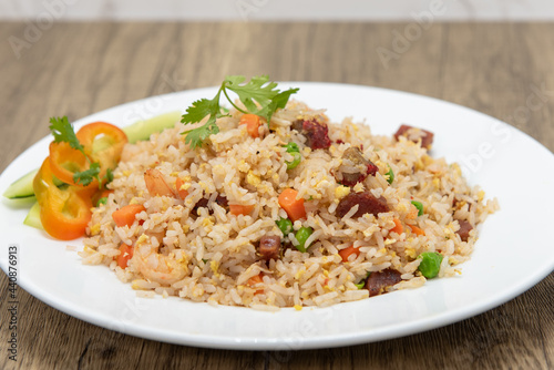Hearty bowl of fried rice mixed with meat and vegetables for a complete meal