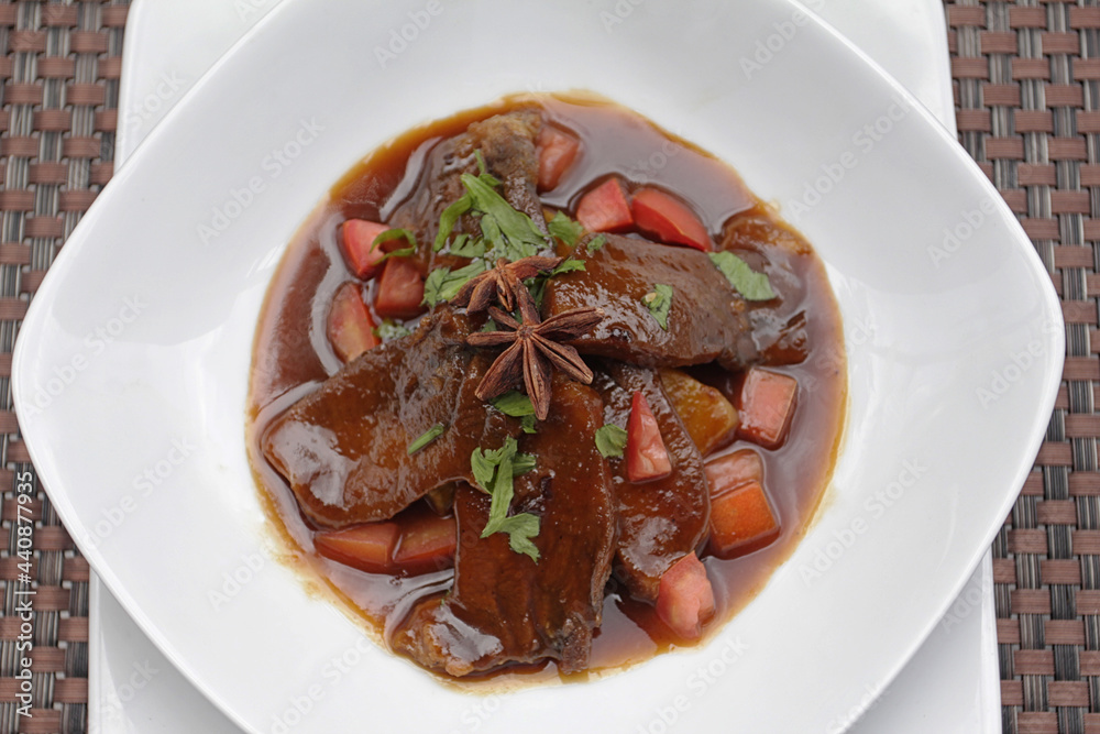 Thin slices of soft and tender beef tongue cooked with a variety of vegetables such as potatoes, carrots and beans, in a sweet-tasting spice