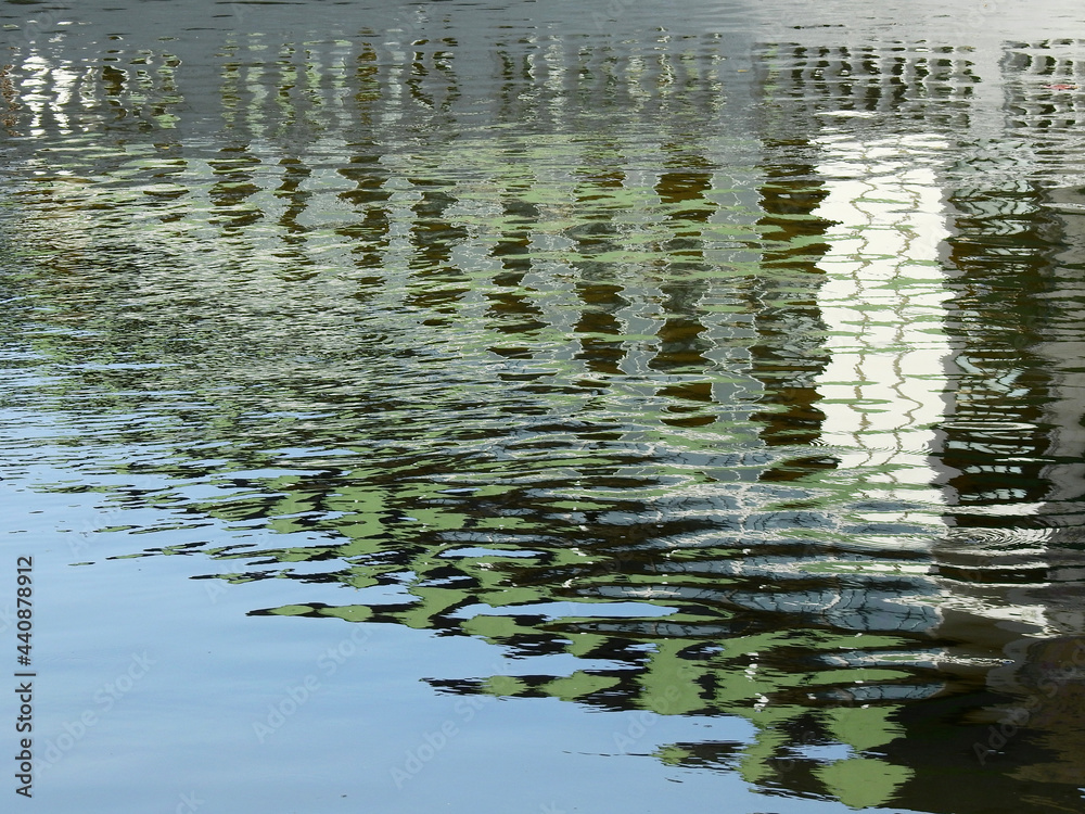 Fototapeta premium abstract water reflection of building with wave in the canal