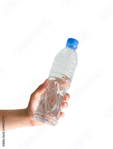 Female hand holding a plastic water bottle on a white background.