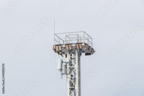 Spotlight pole above have CCTV, phone signal, internet signal in the container yard in the port area the sky background
